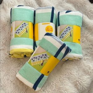 A set of 4 Mint and Navy Beach Towels with Palm tree design.